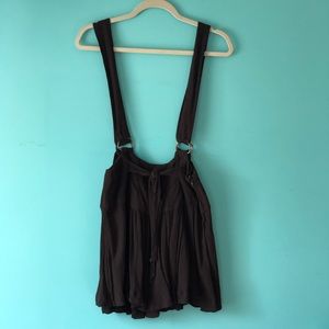 Free People black skirt with attached suspenders.